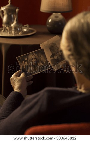 Grandma watching photos of the members of her family