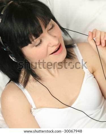 A young woman listens to music on the headphones