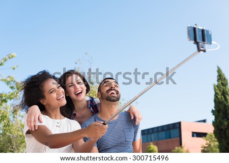 Friends taking a photo with a selfie stick
