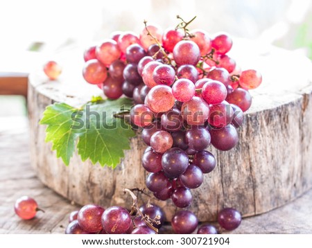 Grapes on wooden table, close-up.