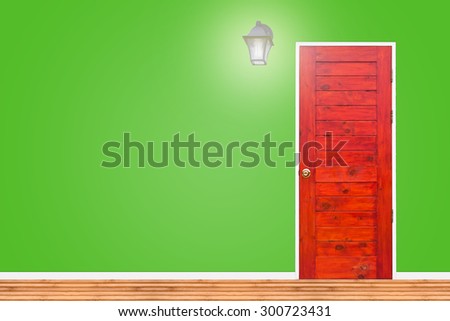 Wooden door and lamp with isolated green wall texture.