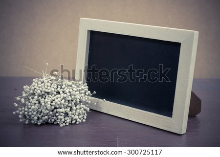 Vintage photo frame on wooden table over grunge background, Still life style