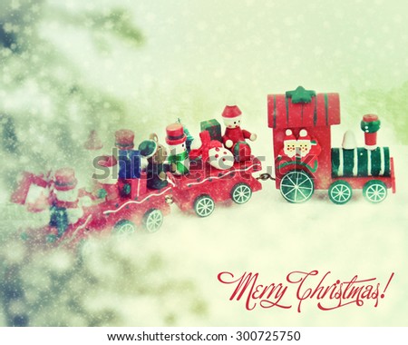 Santa Claus and snowman in a toy train.