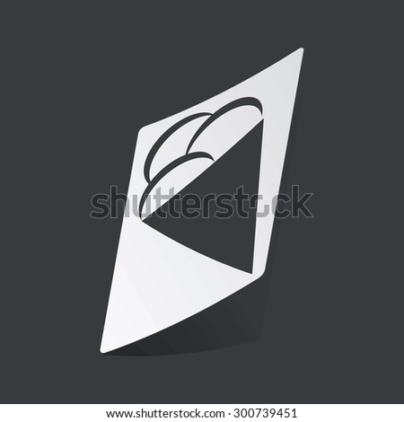 White sticker with black image of ice cream cone, on black background