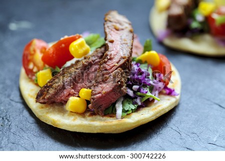 Beef steak tortillas with sweet corn, avocado and tomato salsa and red cabbage coleslaw