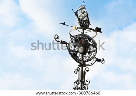 Street lamp in the form of a globe on the sky background