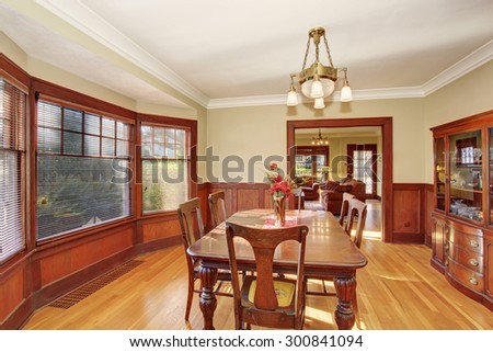 Well lit, and put together dinning room with dark wood dinning set.