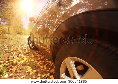 fragment the car in the autumn landscape Royalty-Free Stock Photo #300841985
