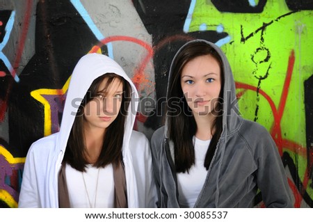 a picture of two teenagers  in hoods