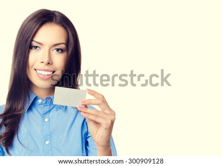 Portrait of cheerful smiling businesswoman showing business or plastic credit card with blank copyspace for text or slogan message