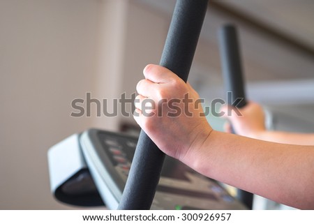 Hands of woman or lady running on treadmill for exercise background
