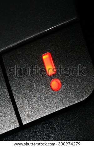 Exclamation mark. Icon note, keyboard, a warning sign. Bright orange, note keyboard button, isolated on dark background. Macro. Attention. Symbol. Business idea.