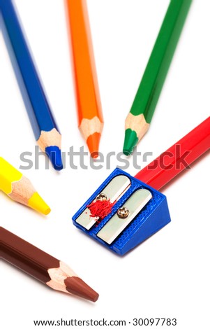 colored pencils and sharpener on a white background