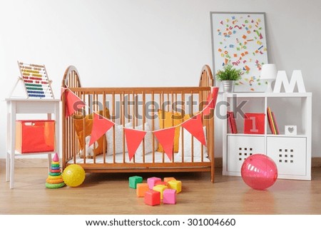 Picture of bright newborn room interior with colorful toys