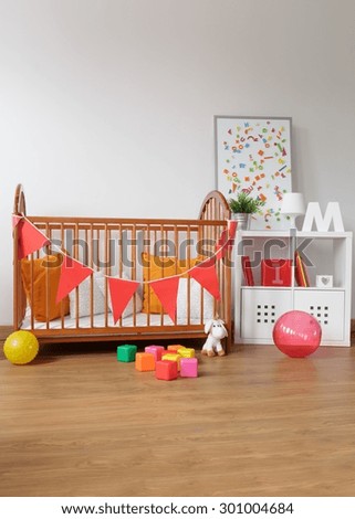 Picture of contemporary wooden furniture in babygirl room