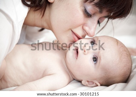 happy mother lying with her newborn daughter