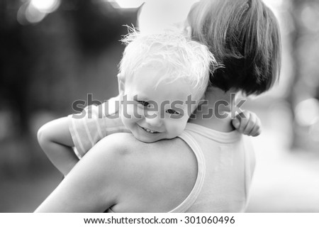 Black and white photo of beautiful middle aged woman and her adorable little grandson
