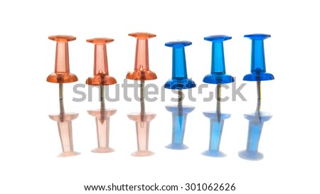 Stationery Push Pin photo illustration. Blue, green, red and yellow push pins set in various configurations and situations.