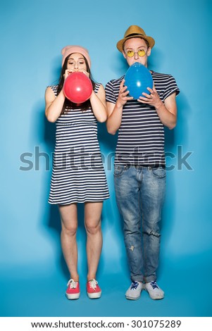 funny couple in love with balls in the studio