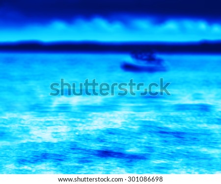 Horizontal vibrant blue boat on lake bokeh background