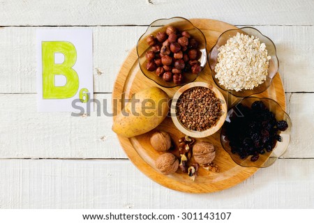 Foods containing vitamin B 6: hazelnuts, potatoes, oatmeal, raisin, buckwheat, walnuts Royalty-Free Stock Photo #301143107