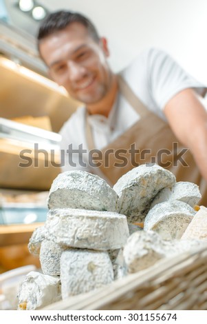 Cheese shop worker with new stock