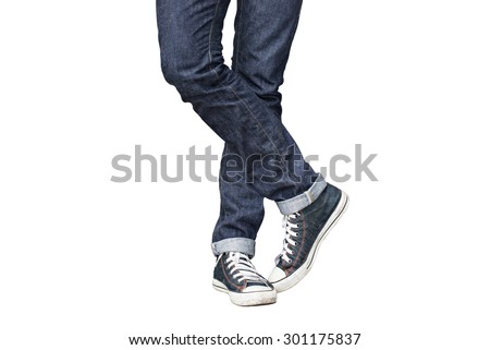 Regular Fit Straight Leg Jeans and Retro Canvas High Top Sneakers isolated on white background, selective focus (detailed close-up shot) Royalty-Free Stock Photo #301175837