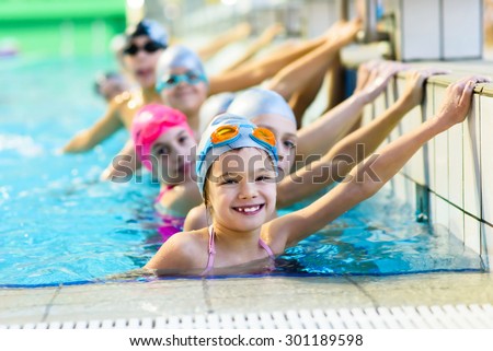 young and successful swimmers pose Royalty-Free Stock Photo #301189598