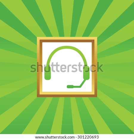 Image of headset in golden frame, on green abstract background