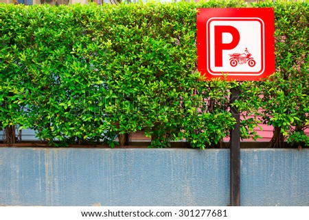 Red Color Motorbikes Parking with empty space on the left side of small tree background