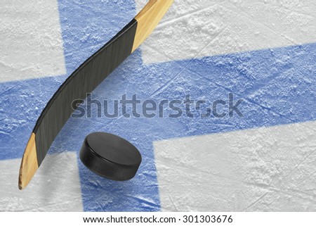 Hockey puck, stick and a fragment of an image of the Finnish flag