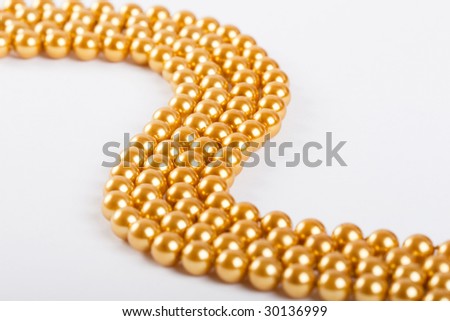 Mardi-gras beads on white background