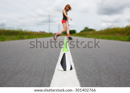 Cone on the background of silhouette roller skate girl at summer time