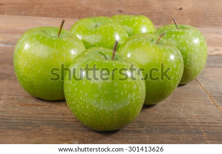 Fresh green apples on wooden background