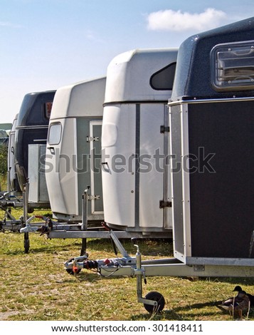 More horse trailers in a row Royalty-Free Stock Photo #301418411