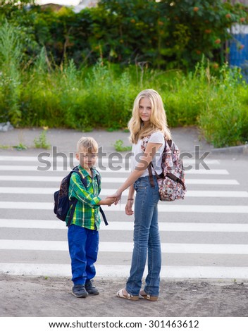 Children stand near a pedestrian crossing