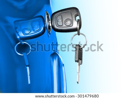 Key at car doors. Closeup with shallow DOF. Picture with space for your text.