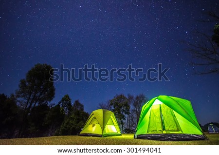 camp in forest at night with star
