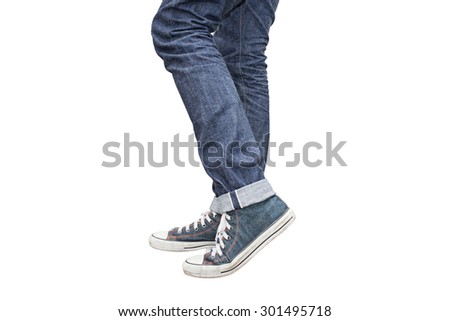 Regular Fit Straight Leg Jeans and Retro Canvas High Top Sneakers isolated on white background, selective focus (detailed close-up shot) Royalty-Free Stock Photo #301495718