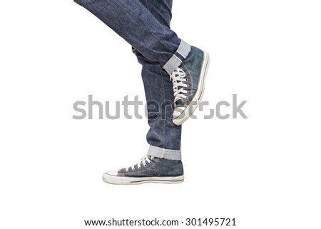 Regular Fit Straight Leg Jeans and Retro Canvas High Top Sneakers isolated on white background, selective focus (detailed close-up shot) Royalty-Free Stock Photo #301495721