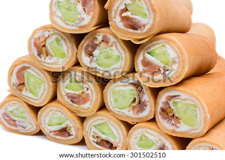 rols of pancake with fish and cucumber isolaeted on white background