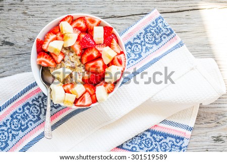 oatmeal with poppy seeds, raisins, strawberries and banana, a healthy breakfast,clean
eating