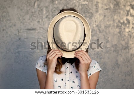 Young girl with hat. Hides her face.Depression.Photo tinted and styled with vintage photo. Royalty-Free Stock Photo #301535126