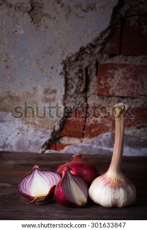 Onion and garlic on wooden table