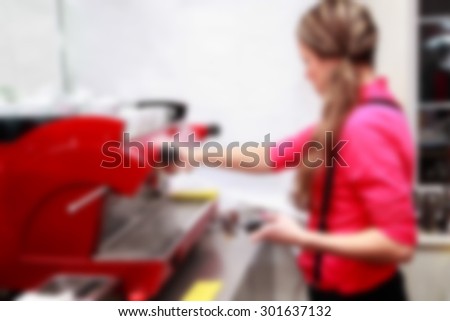 She makes coffee for the coffee machine, the blurred background, blurred picture.