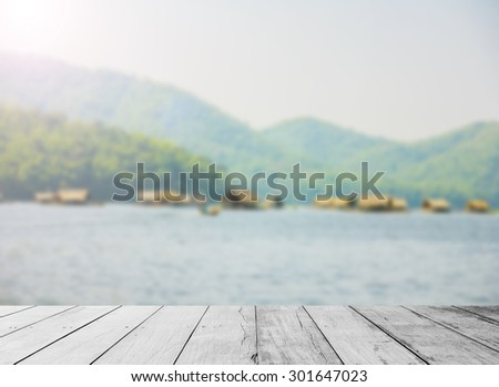 The old wooden floor with river background. river with mountain. bamboo boat