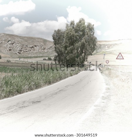 Winding Asphalt Road between Spring  Fields of Sicily, Retro Image Filtered Style