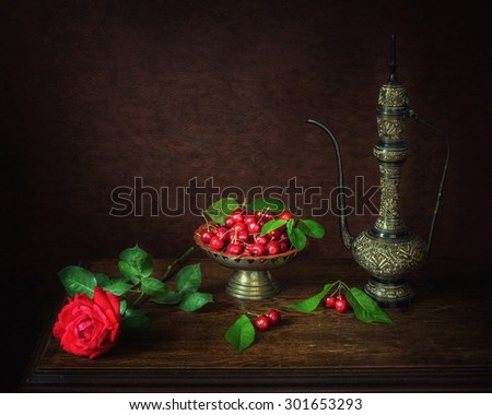 With cherries and a rose