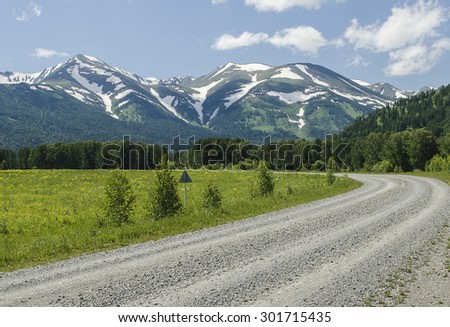 the road to snowy mountains Royalty-Free Stock Photo #301715435