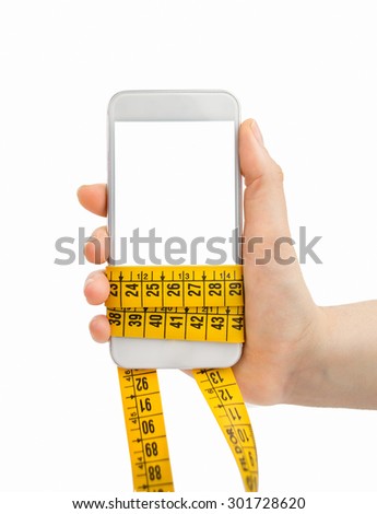 hand holding the smart phone with the measuring tape around as concept of reducing the invoice of phone line and surfing in the web and app of healthy life and diet